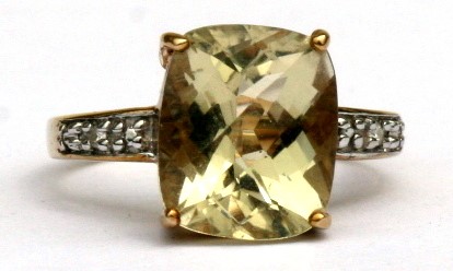 A 9ct gold & citrine ring with diamond set shoulders, approx UK size 'N'.