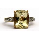 A 9ct gold & citrine ring with diamond set shoulders, approx UK size 'N'.