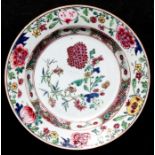 A Chinese famille rose plate decorated with flowers and foliage, 23cms (9ins) diameter.