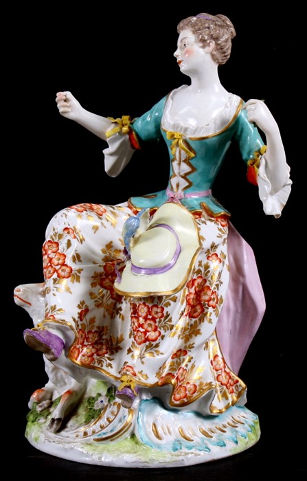 A 19th century English porcelain group of a young girl with a sheep, with gold anchor mark to the