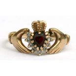 A 9ct gold Claddagh ring set with a central garnet, approx UK size 'Q'.