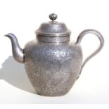A late 19th / early 20th century Chinese white metal teapot, highly decorated with lotus foliate