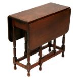 A mahogany gate-leg table of small proportion, on turned legs, 58cms (23ins) wide.