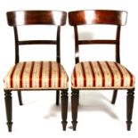 A pair of early 19th century mahogany dining chairs on turned front supports (2).