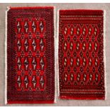 A pair of Persian Baluch woollen handmade rugs with geometric design on a red ground, each approx