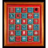 A framed Texaco collection of 30 British Army badges together with four wall shields including REME,