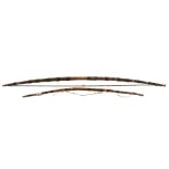 An ethnic / tribal longbow, 147cms (58ins) long; together with a similar smaller bow, 103cms (40.