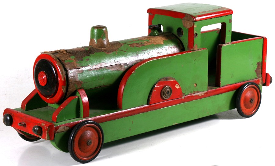 A vintage painted wooden pull-along locomotive, 82cms (32.25ins) long.