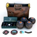 A set of four Poole Park Bowling Club lawn bowls with associated cloth badges; together with a boxed