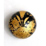 A 19th century Japanese lacquered scroll weight decorated with gilded flowers on a black ground, 5.