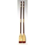 A pair of painted wooden oars, 134cms (94ins) long.