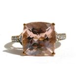 A 9ct gold morganite and diamond ring, set with a large square morganite and diamond shoulders.
