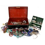 A tin deed box containing a large quantity of costume jewellery.