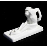 A white porcelain Cubist figure of a seated baboon, with indistinct blue mark to underside, 14cms (