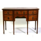 A Regency style bow fronted mahogany sideboard, the central frieze drawer flanked by cupboards, on