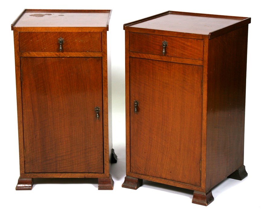 A pair of Art Deco walnut pot cupboards with single frieze drawer above a cupboard, 37cms (14.