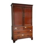 A late 19th century mahogany Heal & Son linen press, the pair of cupboard doors above two short