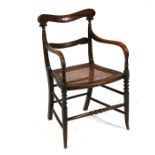 A Regency faux rosewood carver chair with caned seat, on turned front supports.