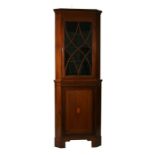 A 19th century mahogany corner cupboard, the glazed top enclosing a shelved interior with cupboard