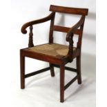 An early 19th century elm country carver chair with drop in seat.