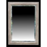 A modern bevel edged rectangular wall mirror, 76 by 106cms (30 by 41.5ins).