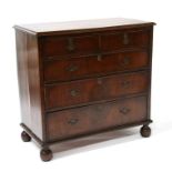 An 18th / 19th century chest, the figured crossbanded rectangular top above two short and three long