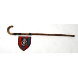 A walking stick mounted with WWI cap badges to include Hackney Volunteer Corp and Royal Engineers,