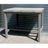 A grey painted pine table on square legs.