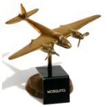 A brass model of the WW2 fighter bomber the De Havilland Mosquito with spinning propellers mounted