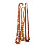 Two strings of faceted amber beads, total weight 162g; together with an amber coloured bead necklace