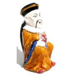 A continental figural water jug modelled as a seated Chinaman, 30cms (11.75ins) high.
