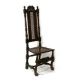 A 17th / 18th century high backed chair with caned seat.