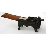 A 19th century continental cast iron tobacco slicer, stamped 'GESETZL GESCHIITZT', 33cms (13ins)