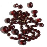 A faceted cherry amber Bakelite bead necklace, the largest bead 2cms, weight 50g.
