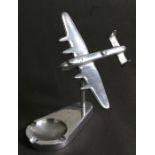 An aluminium model of the iconic Avro Lancaster mounted on its aluminium ashtray base. Wingspan