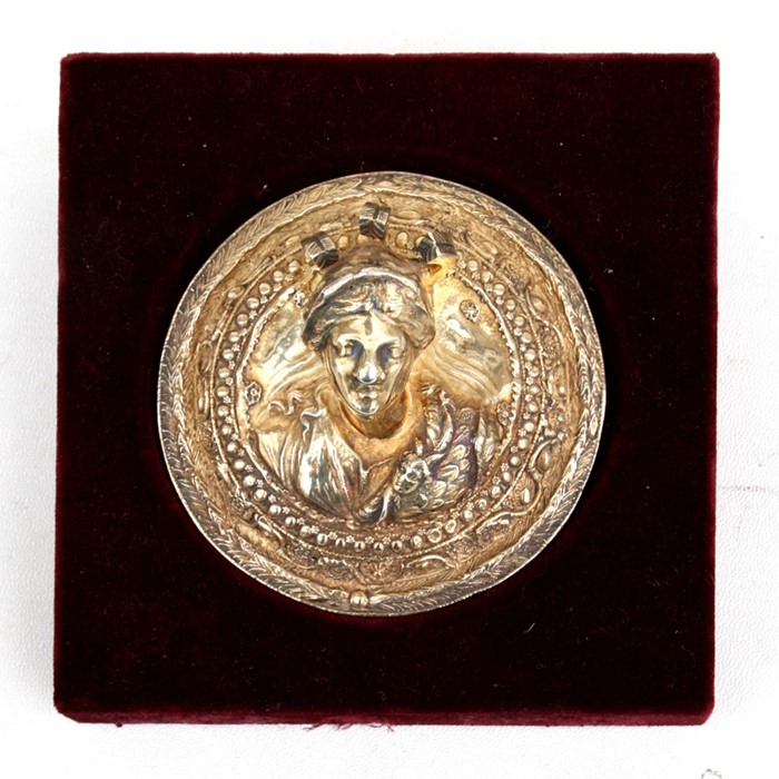 A Greek Armaos 925 silver gilt roundel decorated in relief with a mythical classical figure,
