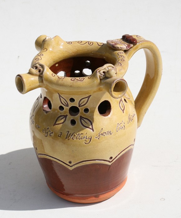 A Mottoware puzzle jug - My Wits Will Give Good Ale To Sup Or Else A Wetting From This Merry Cup -