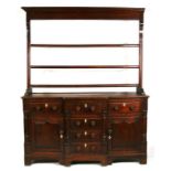 An late 18th / early 19th century North Country oak dresser, the open plate rack with three