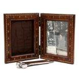 An Edwardian mahogany folding double photo frame with gilt decoration containing a photo of