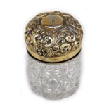 A Victorian silver gilt mounted cut glass dressing table jar, London 1900, 9cms (3.5ins) high.