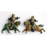 A pair of Chinese Sancai glaze wall plaques depicting warriors riding a mythical beast, 22cms (8.