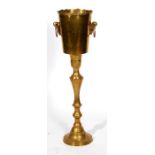 A brass champagne bucket on stand, 86cms (33.75ins) high.