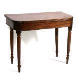 A 19th century mahogany tea table on turned legs, 91.5cms (36ins) wide.