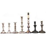 Two pairs of silver plated candlesticks; together with three single silver plated candlesticks.