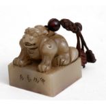 A Chinese soapstone seal surmounted with a temple lion, six character mark to the matrix, 5.5cms (