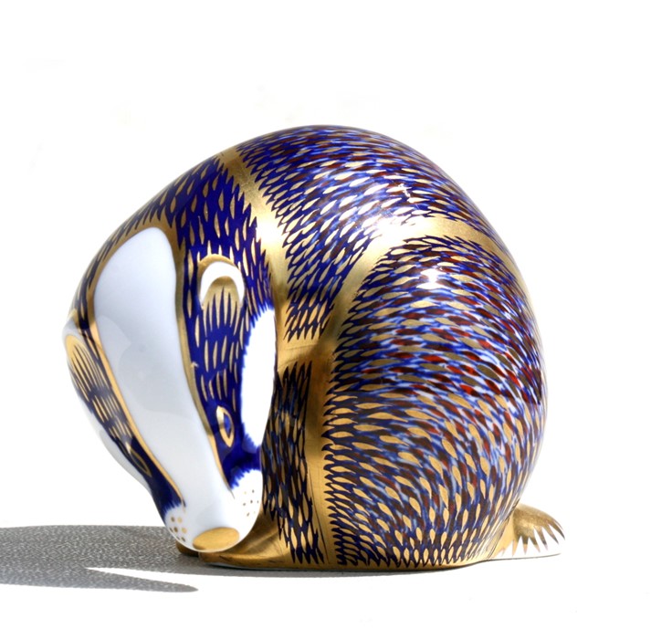 A Royal Crown Derby paperweight modelled as a badger with gold stopper, 7cms (2.25ins) high.