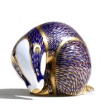 A Royal Crown Derby paperweight modelled as a badger with gold stopper, 7cms (2.25ins) high.