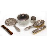 A four-piece silver dressing table set, Birmingham 1962 a silver lidded powder bowl together with