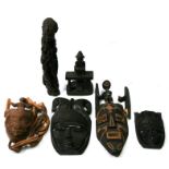 A group of African hardwood carvings to include figures and masks.