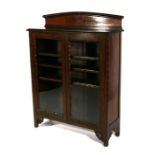 A mahogany two-door glazed bookcase, 91cms (35.75ins) wide.